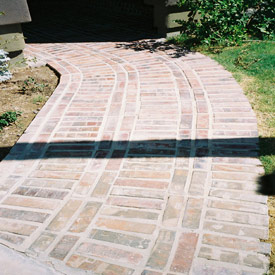 A brick walkway in Arizona after years of neglect and before contacting Desert Tile and Grout Care