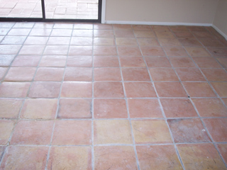 The tile flooring of this home is dull and faded before cleaning by Desert Tile and Grout Care