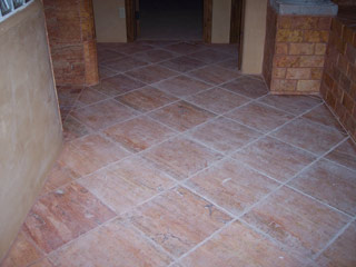 Dirty stone floor before services by Desert Tile & Grout