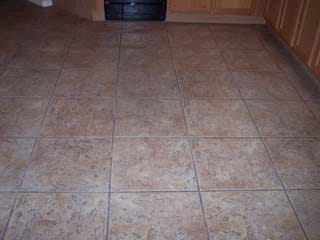 A Phoenix AZ dirty ceramic tiled floor before grout cleaning service