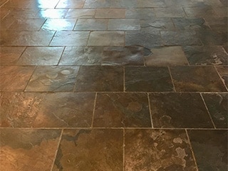 This picture shows a slate floor before it is cleaned