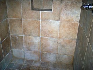 unsealed shower tile with stains